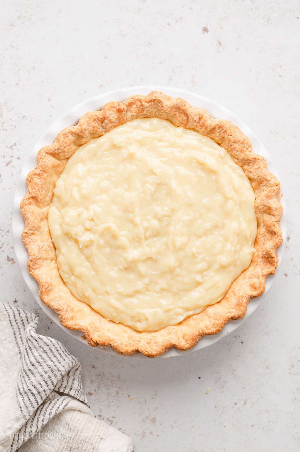 A pie crust filled with coconut cream filling.