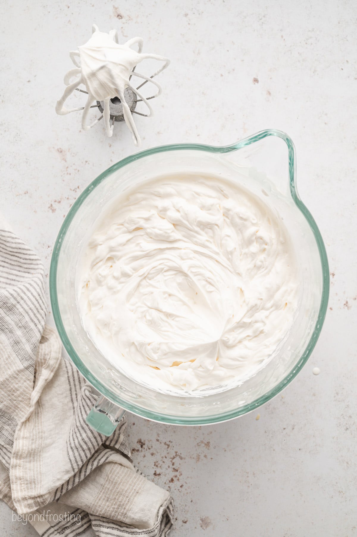 Whipped cream topping in a glass bowl.