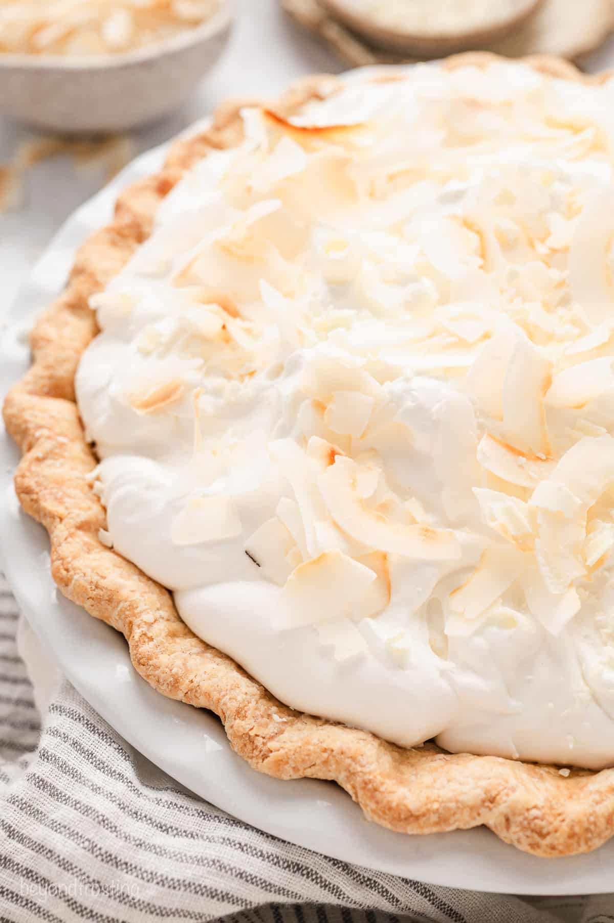 A whole coconut cream pie in a pie plate.