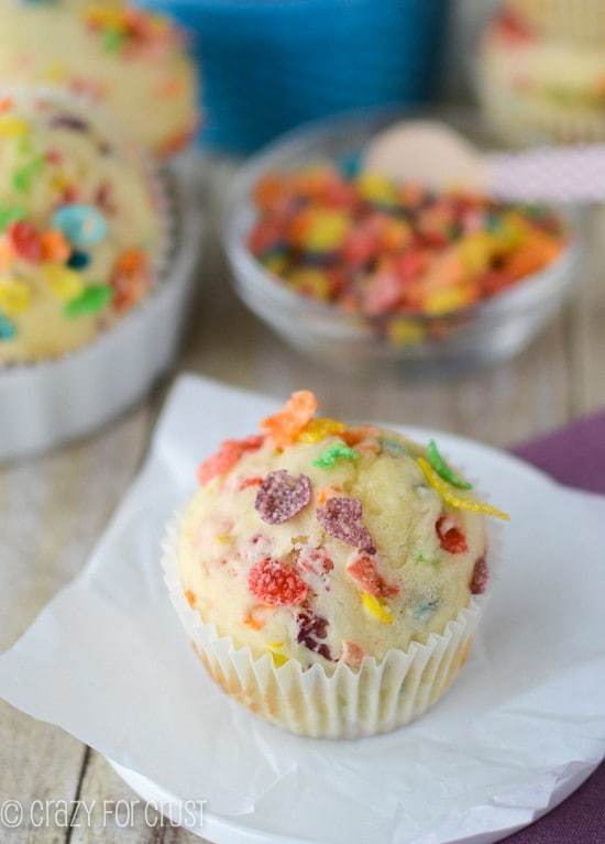 A Fruity Pebbles Muffin on a Plate Covered in Tissue Paper