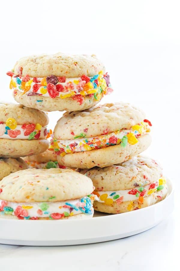 A Stack of Fruity Pebbles Whoopie Pies on a White Serving Platter