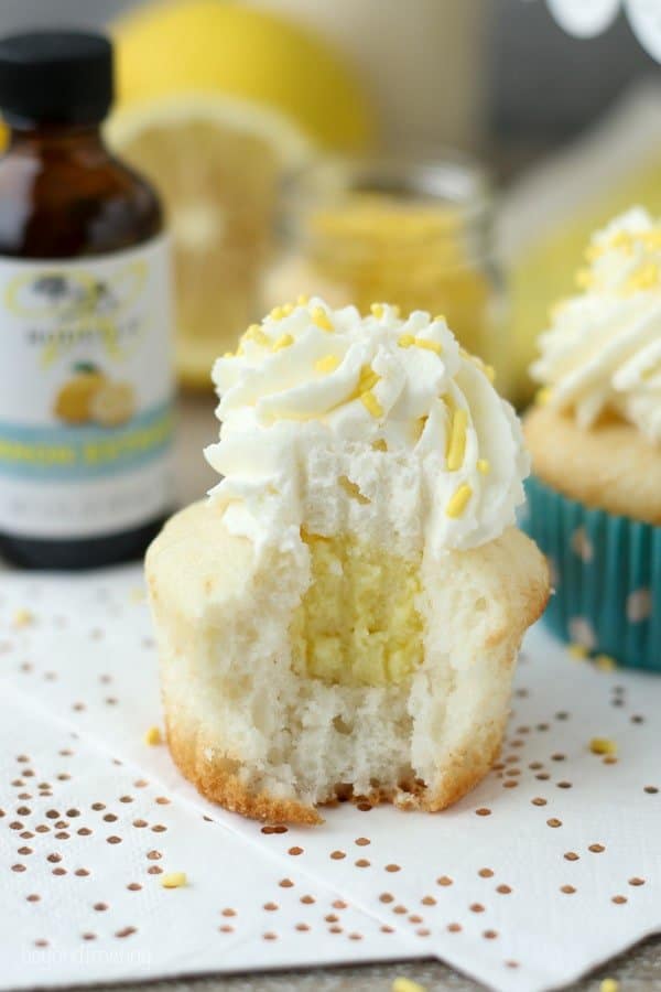 Summer time is calling for Lemon Cream Pie cupcakes. A vanilla cupcake with a delicate lemon mousse and topped with cream cheese whipped cream.