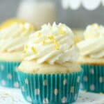 Three lemon cream pie cupcakes in blue cupcake liners.