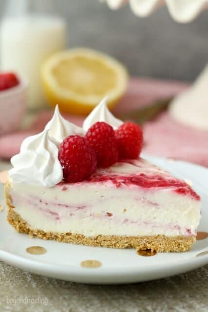 This EASY No-Bake Raspberry Swirl Cheesecake has a buttery graham cracker crust and layers of no-bake cheesecake and a fresh raspberry purée.