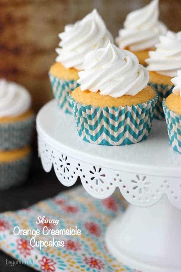 These Skinny Orange Creamsicle Cupcakes are full of flavor but without all the extra calories! The orange flavored cupcake it topped with a fat-free whipped topping.