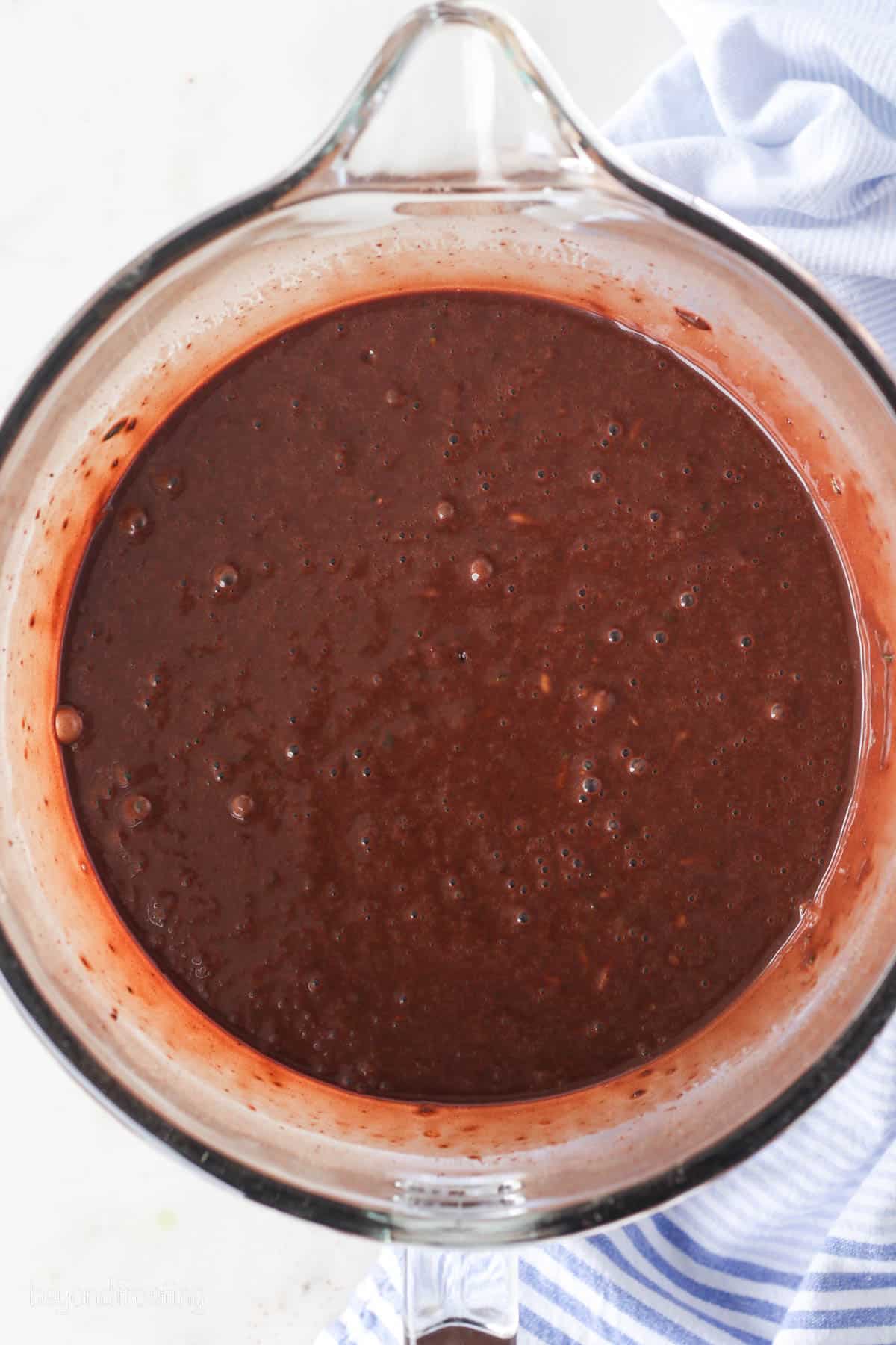 Chocolate zucchini cake batter in a bowl.
