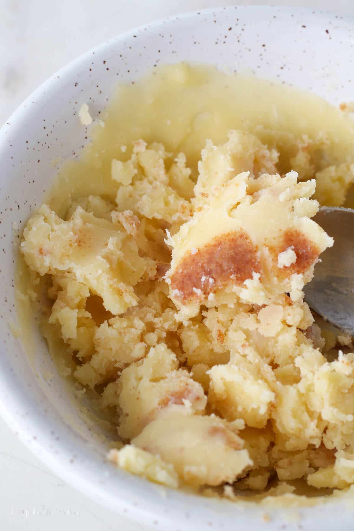 Browned butter in a white bowl.