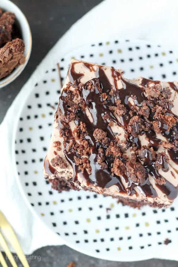 Drool worthy Brownie Batter Poke Cake. A rich chocolate Cake filled with chocolate pudding and topped with a brownie batter mousse and brownie batter glaze.