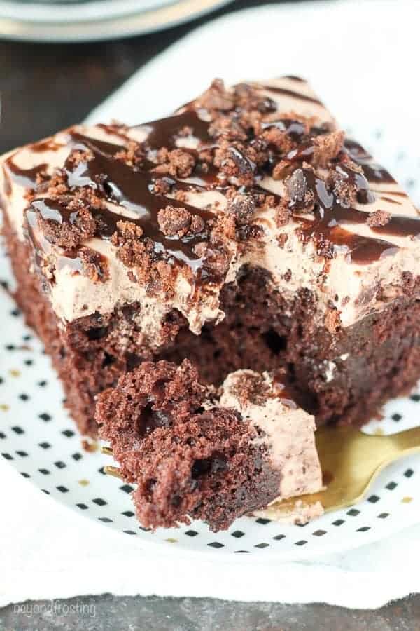 Drool worthy Brownie Batter Poke Cake. A rich chocolate Cake filled with chocolate pudding and topped with a brownie batter mousse and brownie batter glaze.