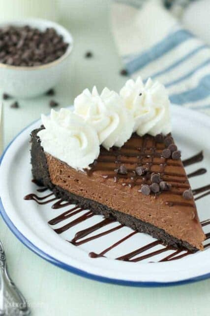 A slice of Kahlua pie on a plate with chocolate chips and whipped cream