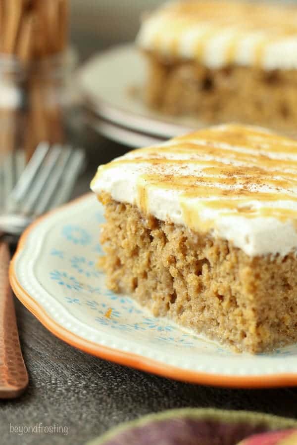 This Pumpkin Spice Latte Poke Cake is a simple pumpkin cake soaked in an espresso cream and topped with a cinnamon mocha whipped cream.