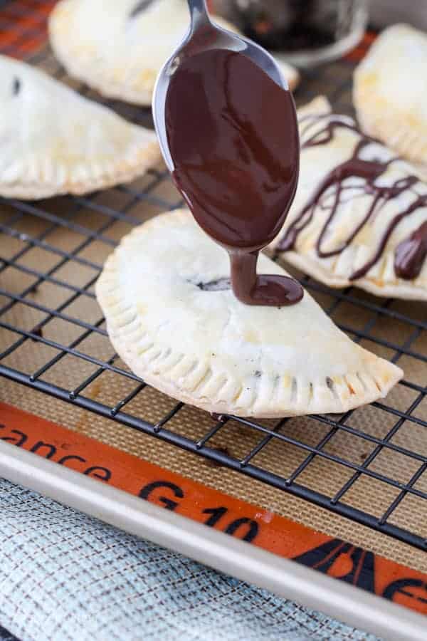These OREO Cheesecake Hand Pies feature a flakey pie crust filled with a creamy OREO cheesecake filling topped with a chocolate ganache.