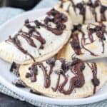 These OREO Cheesecake Hand Pies feature a flakey pie crust filled with a creamy OREO cheesecake filling topped with a chocolate ganache.These OREO Cheesecake Hand Pies feature a flakey pie crust filled with a creamy OREO cheesecake filling topped with a chocolate ganache.