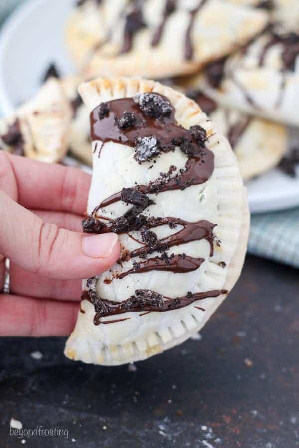 These OREO Cheesecake Hand Pies feature a flakey pie crust filled with a creamy OREO cheesecake filling topped with a chocolate ganache.