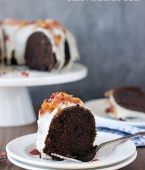 This slice of bacon cake is chocolatey and topped with yummy bourbon bacon crumbles and icing.