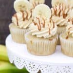 a group of cupcakes on a white cake stand