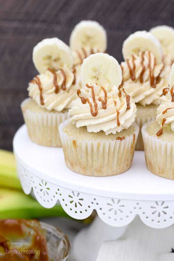 a group of cupcakes on a white cake stand