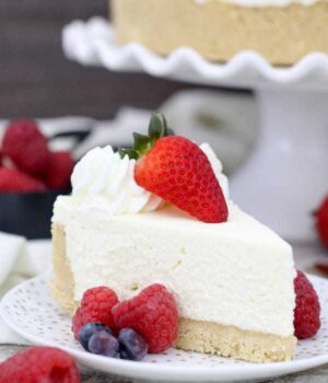 a slice of no-bake cheesecake on a plate with fruit