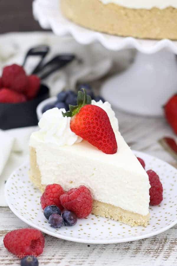 A slice of cheesecake on a plate with fresh fruit