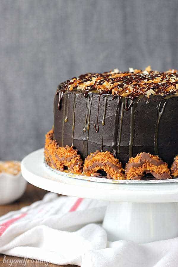 A picture of a chocolate and caramel cake on a white cake plate