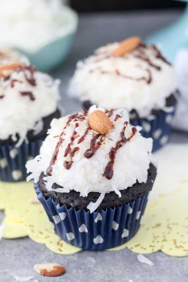 A chocolate cupcake with a coconut frosting