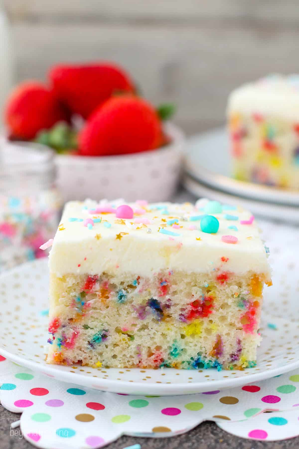 a slice of cake on a plate with sprinkles