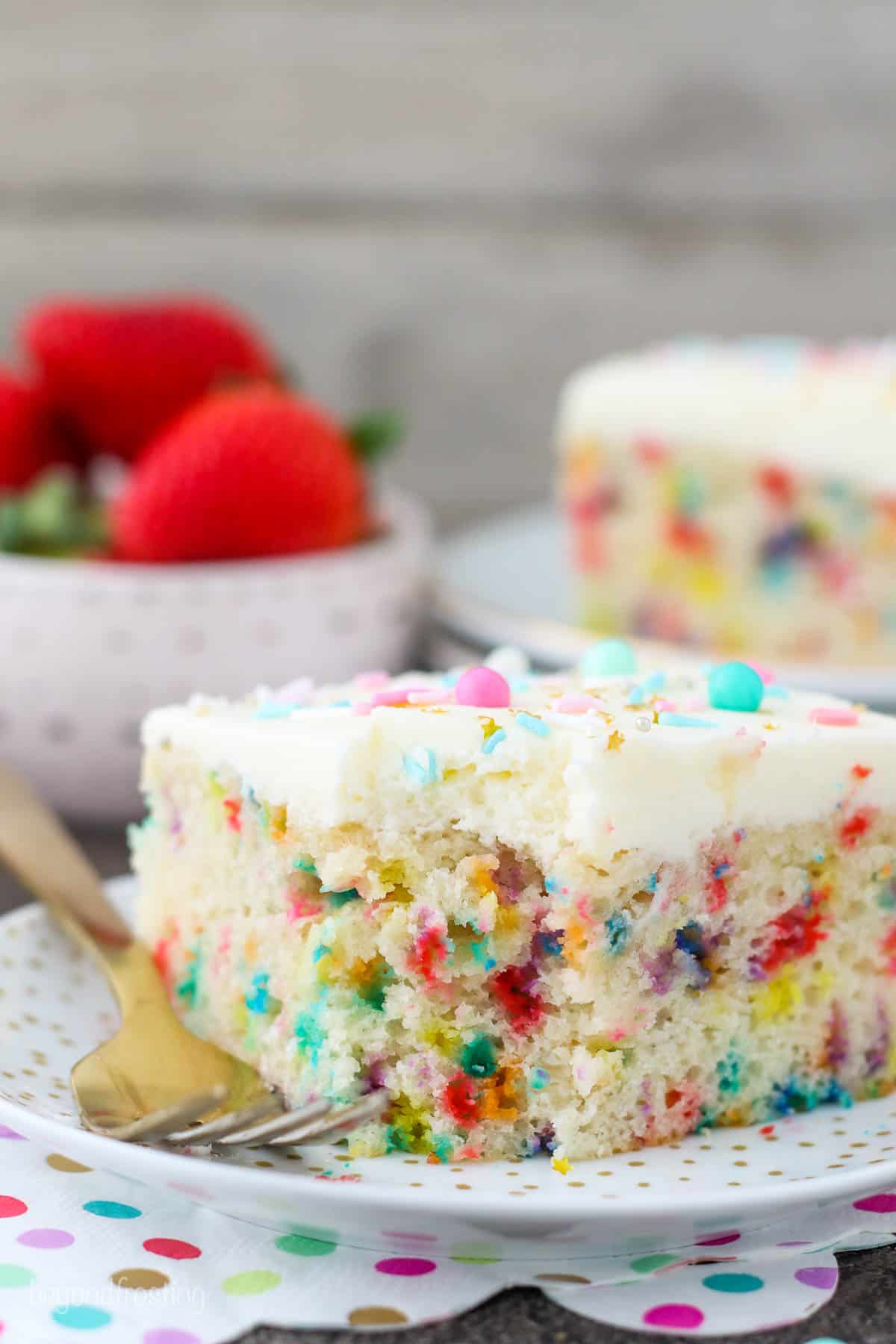 A piece of funfetti cake with a bite taken out of it