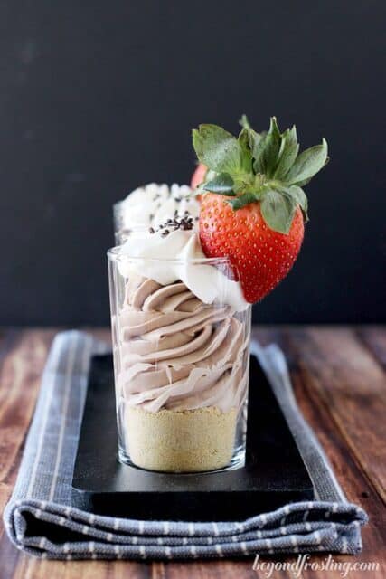 Mini Baileys chocolate cheesecake parfaits infused with baileys irish cream and topped with a strawberry