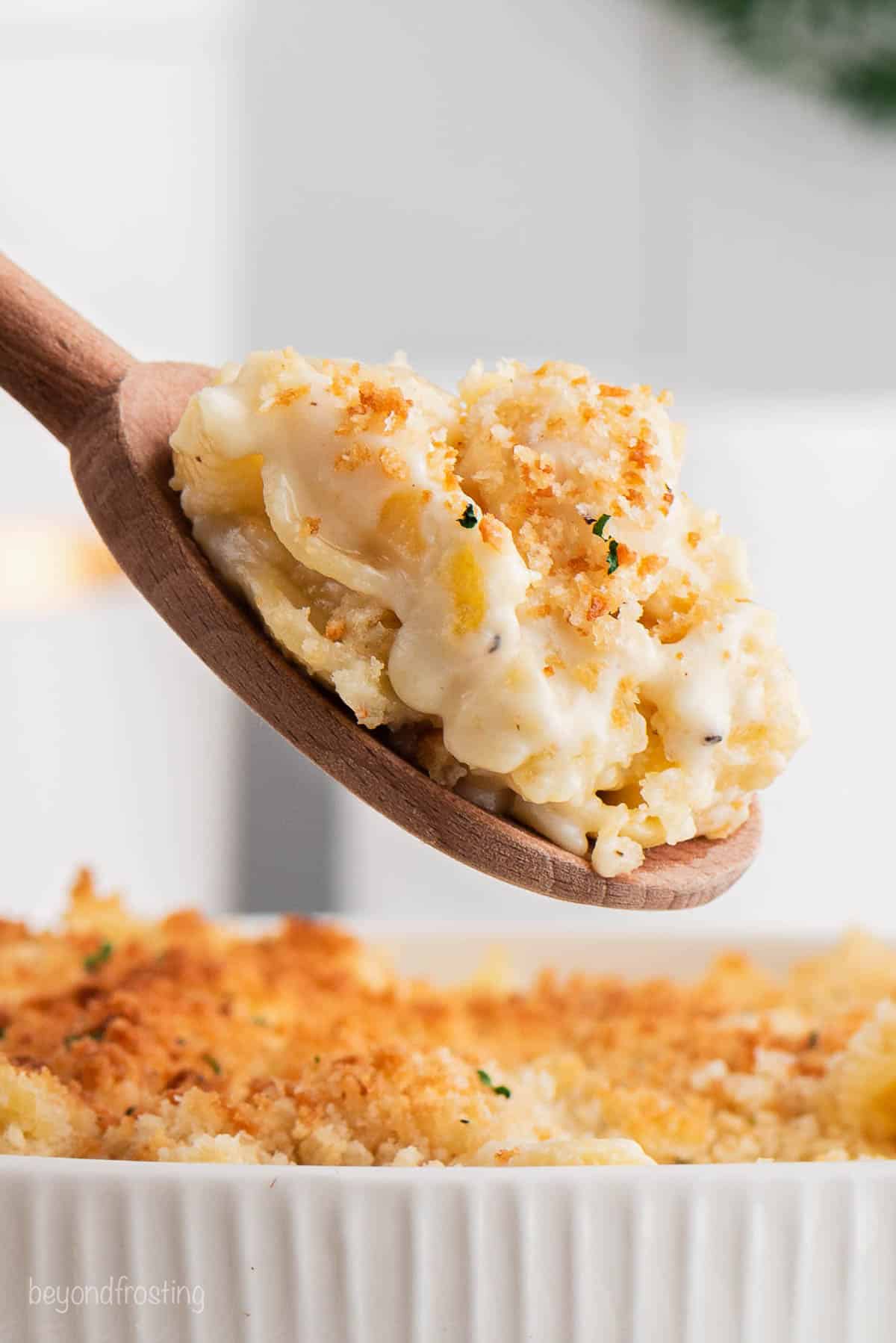 A wooden spoonful of baked mac and cheese