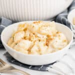 A white bowl of baked macaroni and cheese