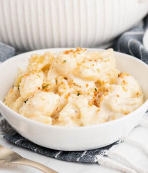 A white bowl of baked macaroni and cheese