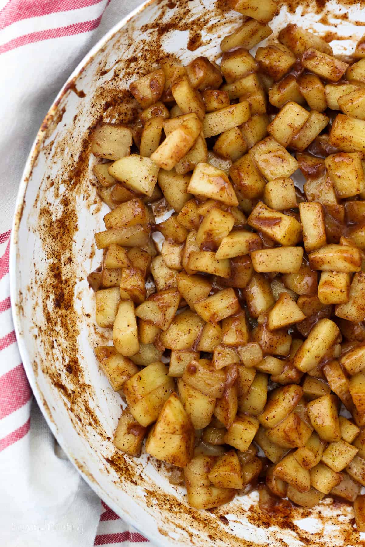 Overhead view of caramelized apple pie filling in a skillet.