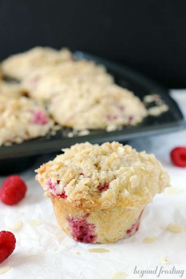 A large raspberry muffins topped with an almond streusel.
