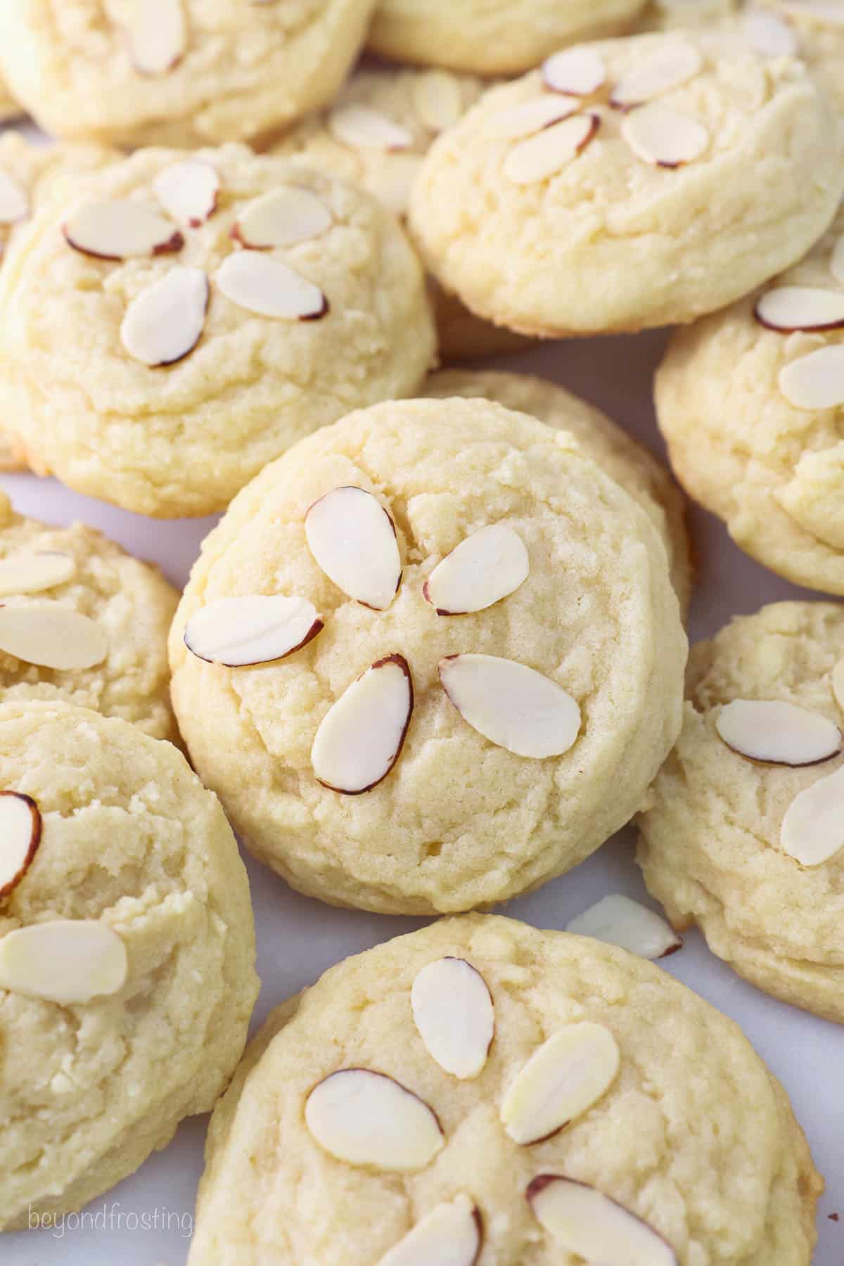 Assorted baked almond cookies decorated with slivered almonds.
