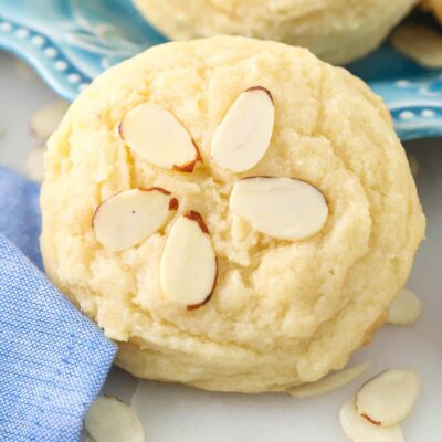 Close up of a almond cookie decorated with sliced almonds.