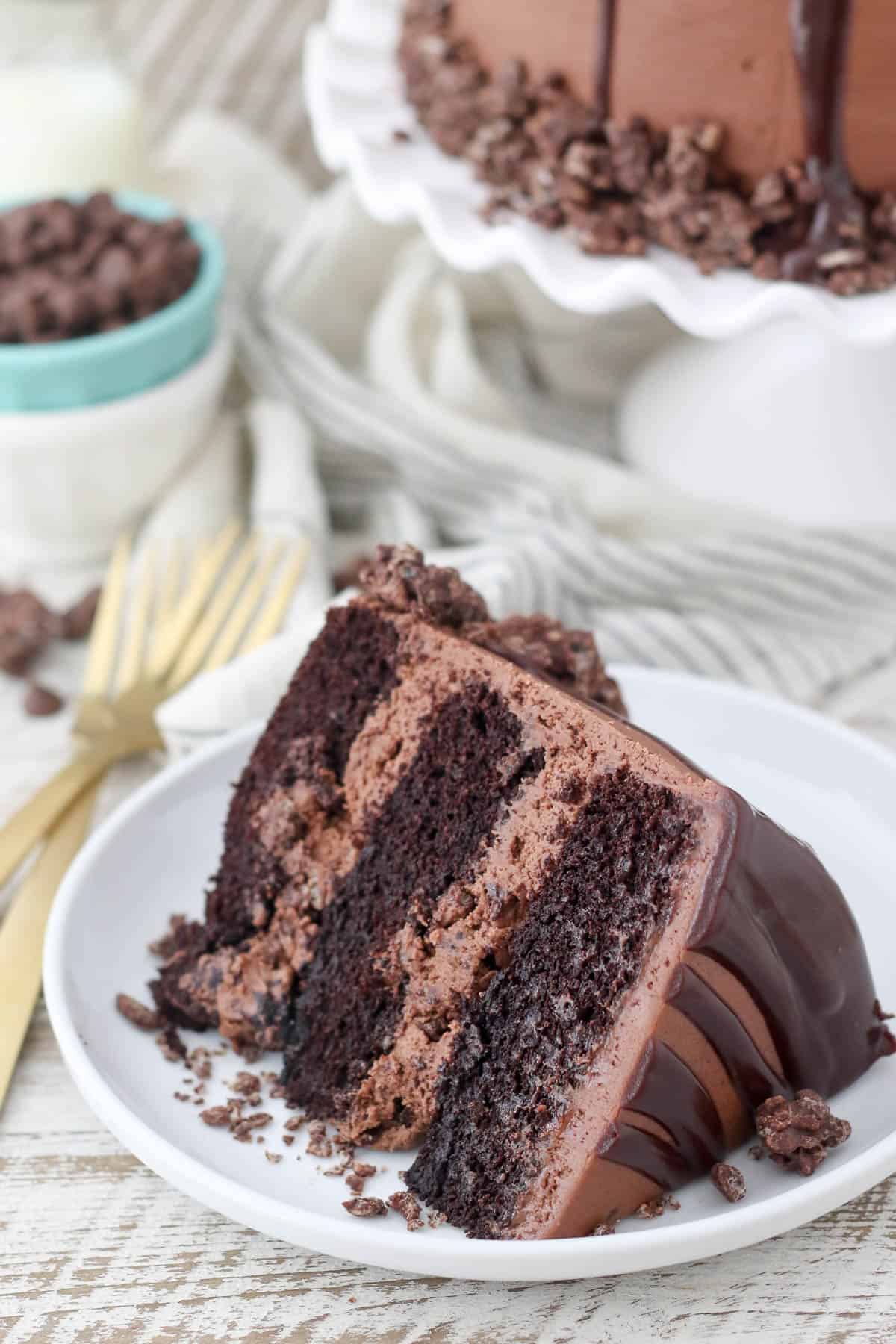 A slice of French silk chocolate layer cake on a white plate.