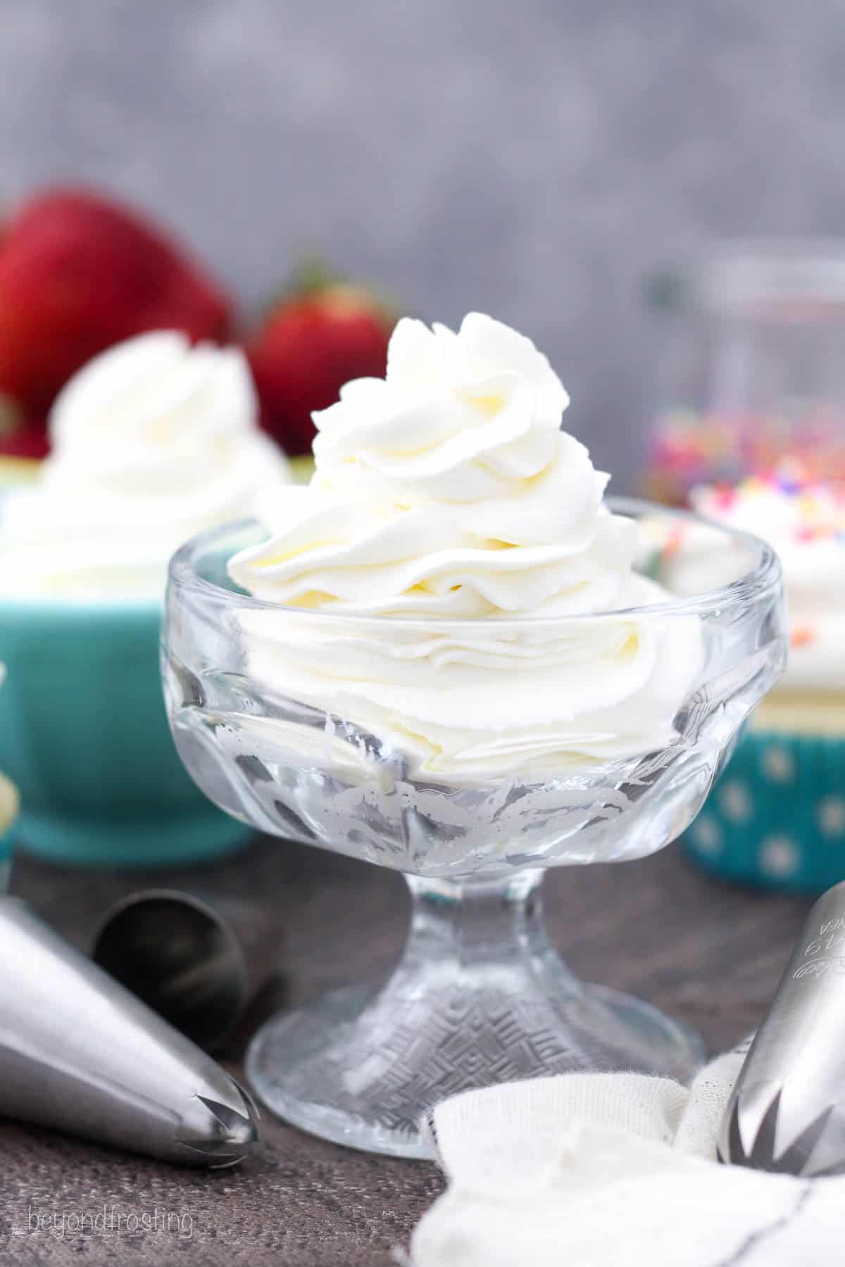 Homemade whipped cream piped into a glass goblet.