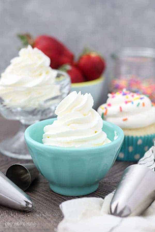 A teal dish filled with piped whipped cream