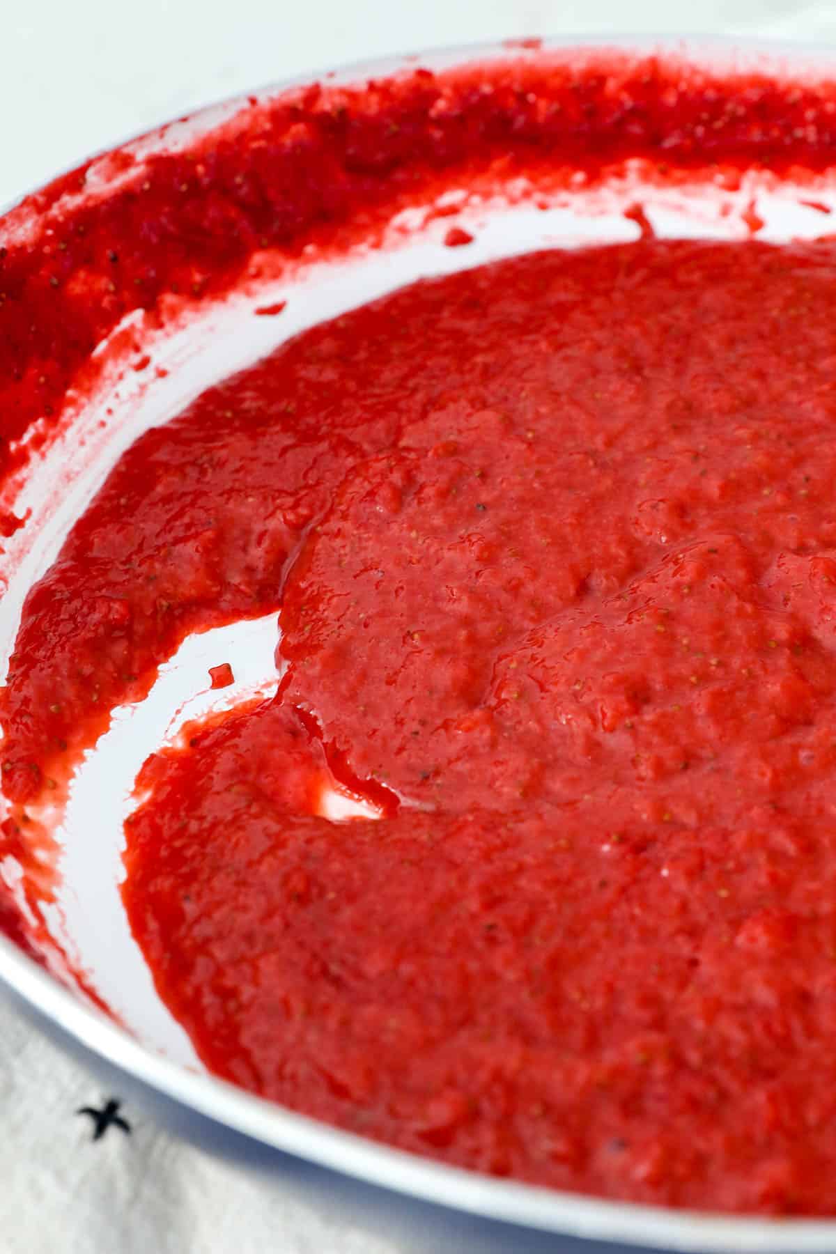 Close up view of strawberry puree in a skillet.