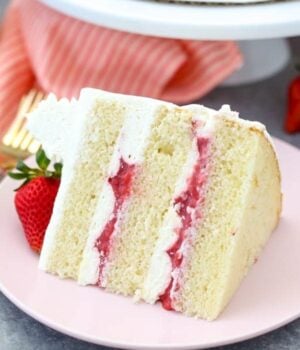 A Slice of Strawberry Mascarpone Cake on a Light Pink Plate