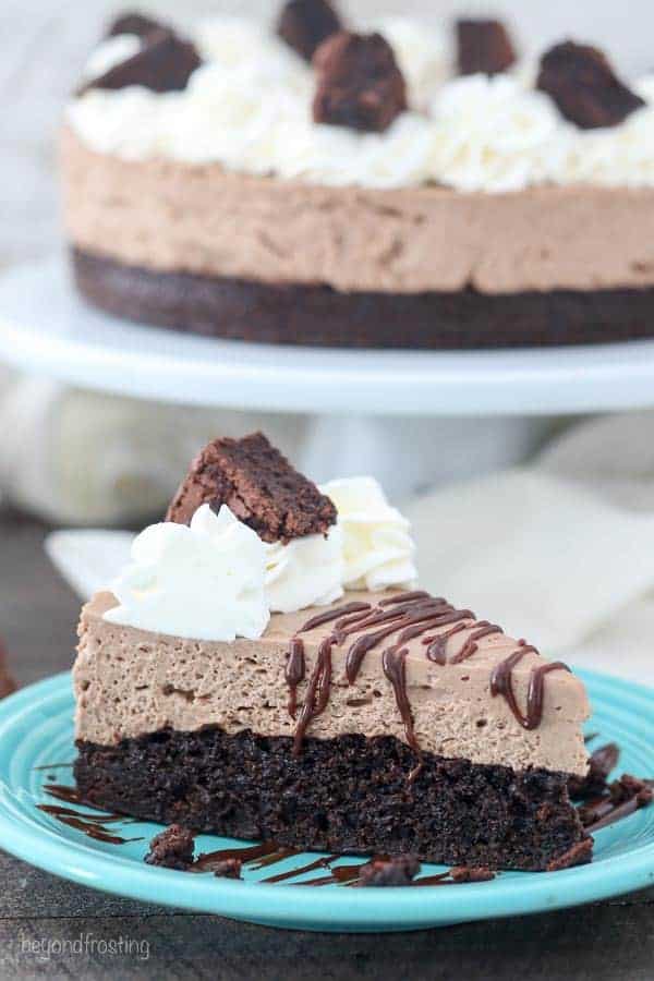 A slice of no-bake chocolate cheesecake with a brownie on the bottom.