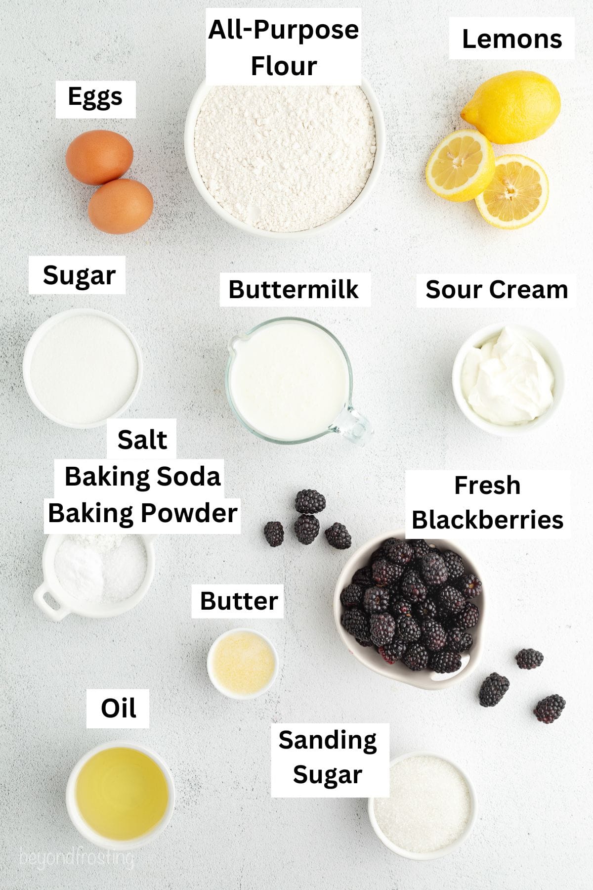 Lemon blackberry muffins ingredients with text labels overlaying each ingredient.