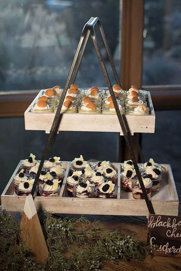 An old flower box is used to hold desserts on this rustic-themed dessert table