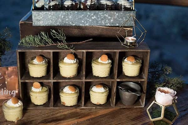 Rustic themed dessert table featured a vintage box filled with mini banana pudding cheesecake