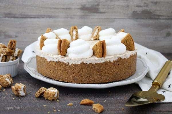 A horizontal photo of an a whole ice cream pie topped with whipped cream and oatmeal cream pies