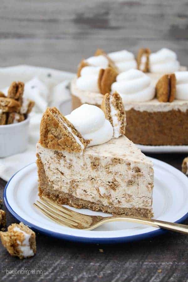 A slice of Ice Cream Pie on a white plate with a blue rim and a gold fork. Garnished with Oatmeal Cream Pies.