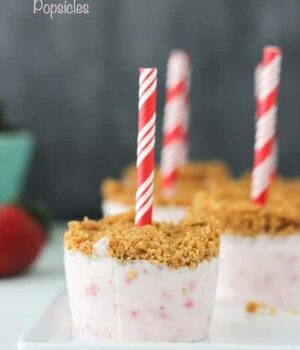 A few Strawberry Marshmallow Popsicle with a graham cracker topping on a platter.