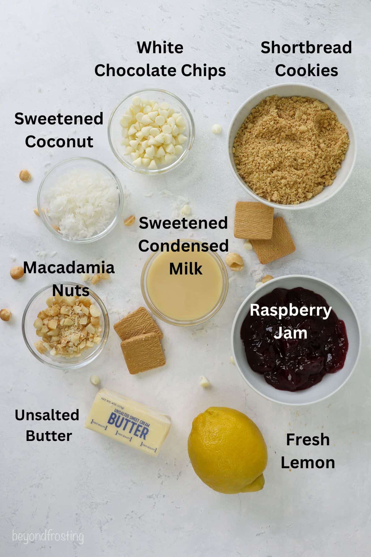Ingredients for lemon raspberry magic cookie bars with text labels overlaying each ingredient.