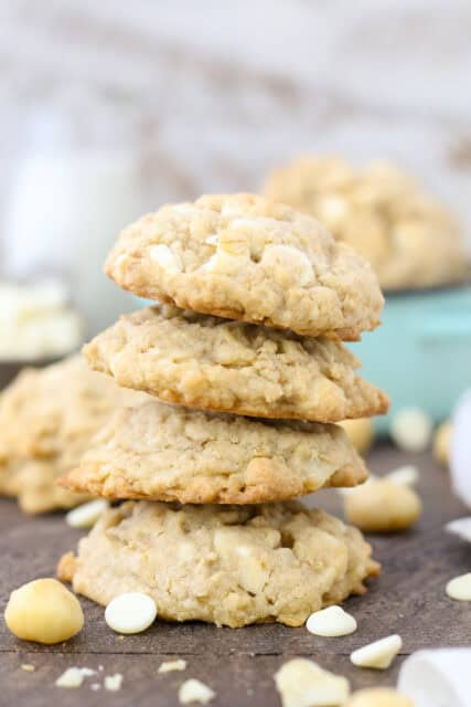 A stack of four oatmeal white chocolate macadamia nut cookies.