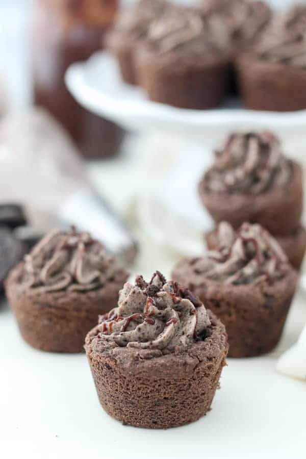 The mini chocolate cookie cup is filled with an Oreo filling and topped with hot fudge and crushed Oreos